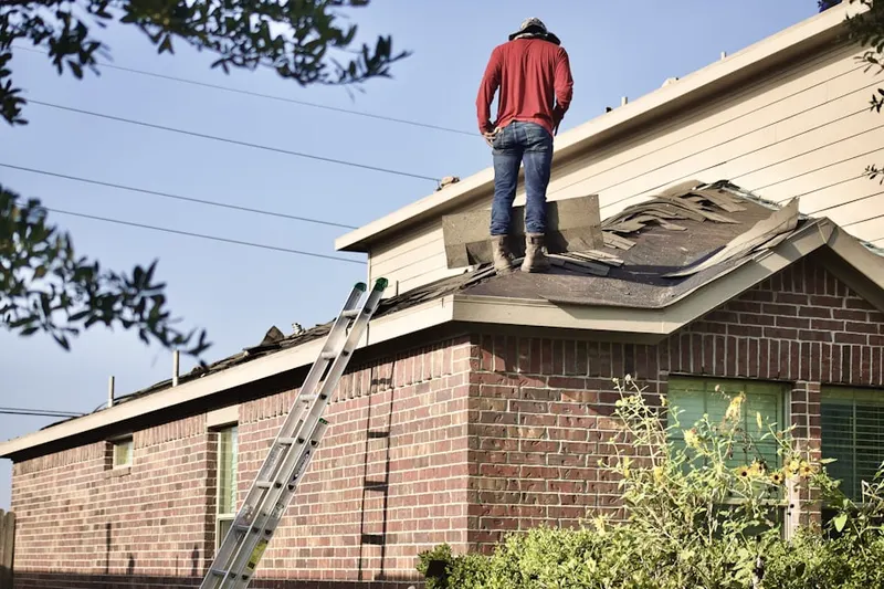 Professional roofer working on a residential roof in Bryn Mawr